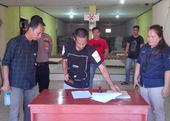 Foto : Tampak Ketua Bawaslu Bolmut, Abdul Muin Wengkeng dan Ketua KPUD Bolmut, Djunaidi Harundja, saat bersama-sama mencermati dokumen logistik pemilu 2024