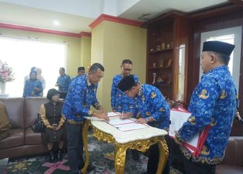 Foto : Pj Bupati Bolmut, Sirajudin Lasena, saat menandatangani SK Pengangkatan Staf Khusus Bupati