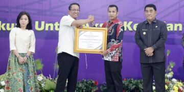 Foto : Wakil Bupati Boltara Mohamad Aditya Pontoh saat menerima penghargaan dari Kementerian Hukum RI